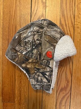 Carhartt Kids Realtree Camo Trapper Hat with White Sherpa Lining and Orange Logo